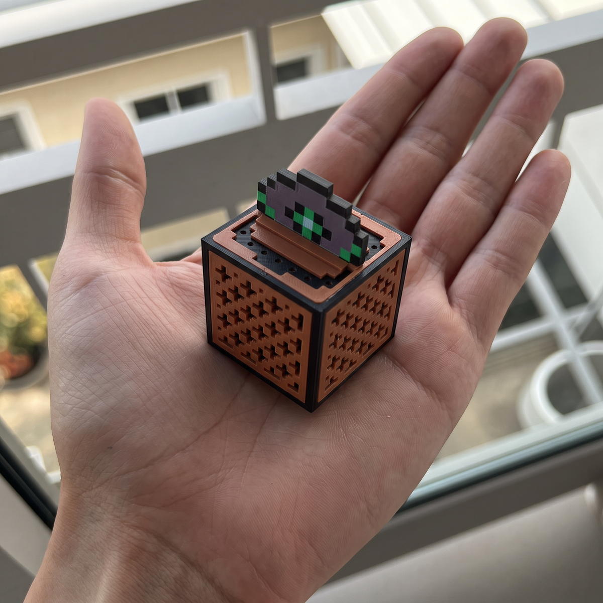 MelodyMite Mini Jukebox sitting in an open hand for scale